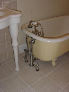 tub on legs with chrome faucet